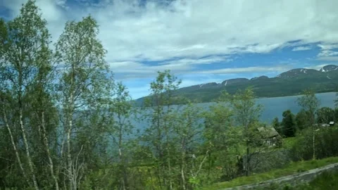 Driving side window view of wooden house on fjord coast in Northern Norway Stock-Footage 340960145