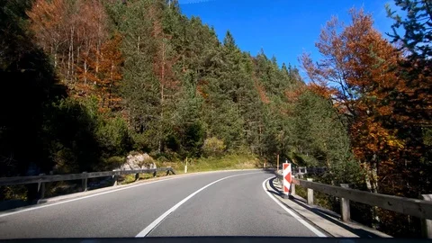 Driving on Slovenia road in valley between Alps and colorful trees Stock Footage 122768340