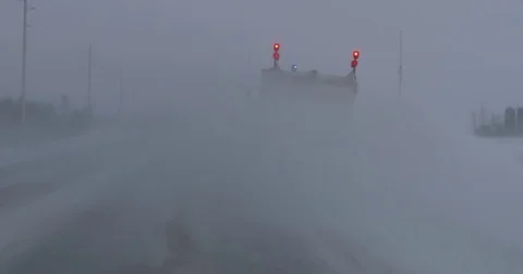 Driving in snow and blizzard behind a snow plow on the highway Stock Footage 71168583