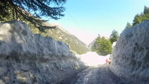 Driving Snow-capped road at ice mountain route Stock Footage 220697608