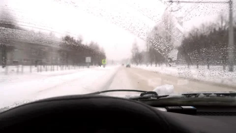 Driving in snow storm. Poor visibility through driver's window on road, Stock Footage 229415282