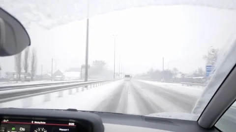 Driving on a snowy highway Stock Footage 72715593