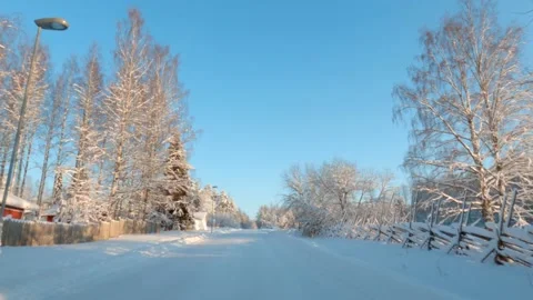Driving on snowy road through winter landscape Stock Footage 146853835