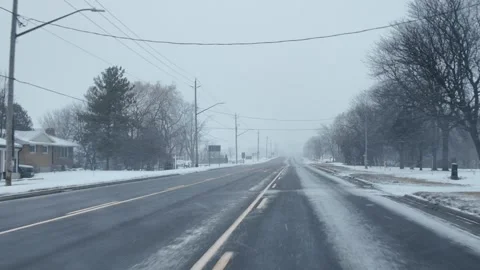 Driving on a Snowy Road Through Winter Weather Conditions Stock Footage 301128488