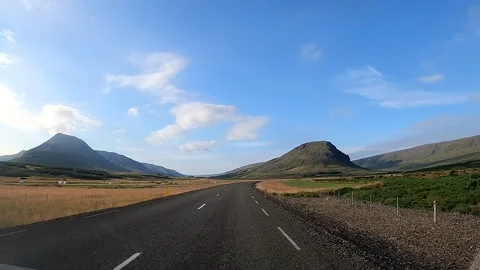 Driving on a straight asphalt road through East Iceland scenic valley Stock Footage 333897452