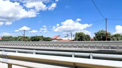 Driving in a street with silver barriers Video stock 209586056
