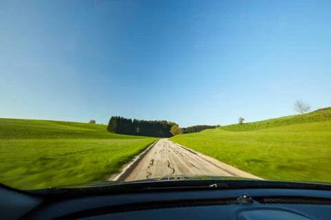 Driving on the street through the meadows Stock Photos