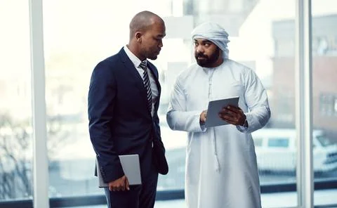 Driving success with efficient collaborations. two businessmen using a digital Stock Photos