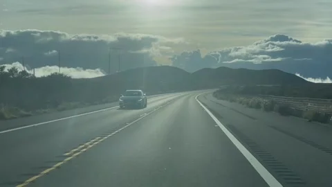 Driving Into the Sun on Desolate Road Видео 196942661