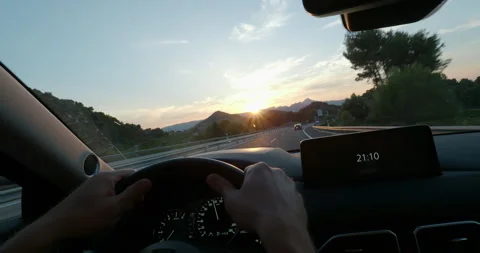 Driving at sunset with dashboard clock display Stock Footage 264928122