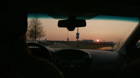 Driving into the sunset on a warm evening road trip Stock Footage 303693978