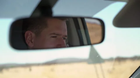 Driving SUV car. Man driver reflection in rear view mirror. Highway road. Stock Footage 168771681