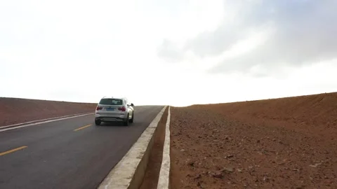 Driving an SUV on the road Stock Footage 243066343