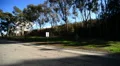 Driving Three Quater Rear 06 Street by a park HD Footage
