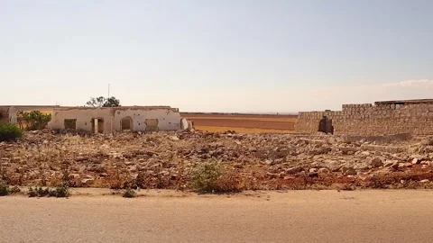 Driving through abandoned war-torn village ruins in Aleppo Syria countryside Stock Footage 320815966