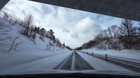 Driving through bridge underpass in snowfall winter highway POV Video stock 333091332