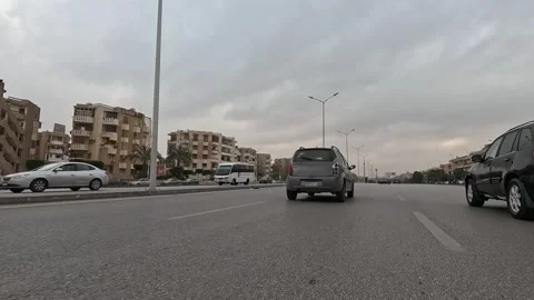 Driving Through Bright City Streets New Cairo Showing Modern Buildings Traffic Stock Footage 330100004