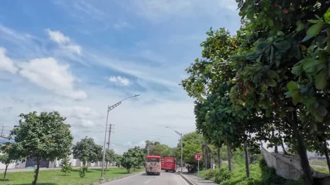 Driving Through Colombian Town with Red Bus Ahead Stock Footage 341368841