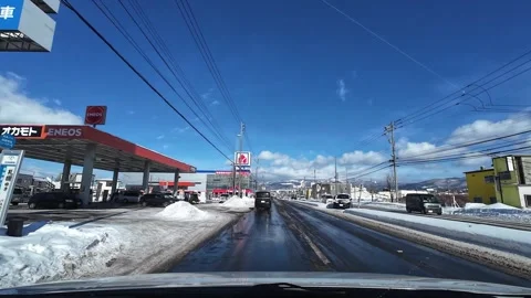 Driving through commercial area with mountain in Hakodate winter city Video stock 333069458