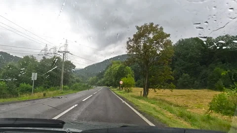 Driving through countryside during summer rain Stock Footage 303383128