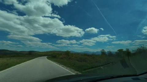 Driving through countryside under bright blue skies. Balkan, Eastern Europe, POV Vidéo 333586959