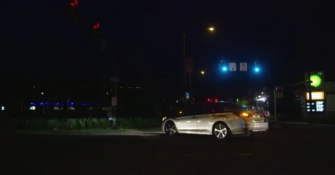 Driving through on a dark intersection at night Stock Footage 77081198