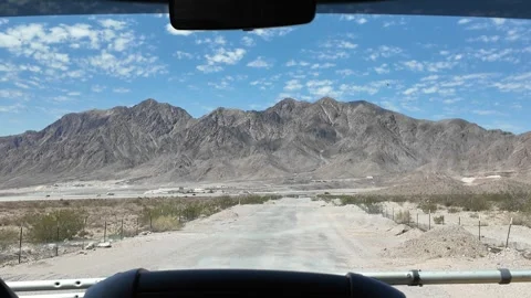 Driving Through Desert Road Towards Majestic Mountain Range Stock Footage 318540249