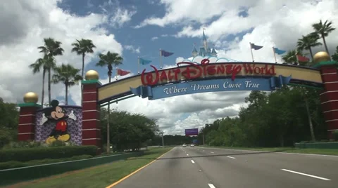Driving through Disney world gate Stock Footage