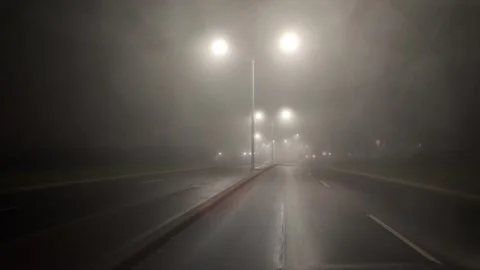 Driving Through Fog on an Empty Street at Night Toward a Crosswalk Stock Footage 301230587