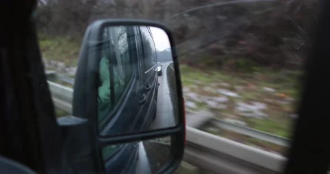 Driving through germany in a dark van watching from a rear view mirror Stock Footage 230317894