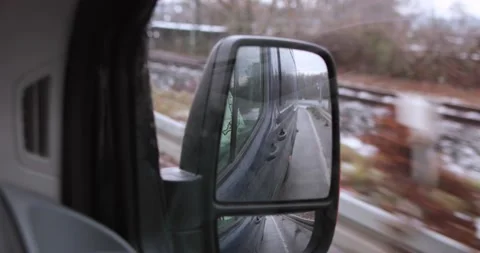 Driving through germany in a dark van watching from a rear view mirror Stock Footage 230318322