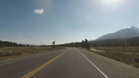 Driving through Grand Teton park, back light 2.7k Ultra HD , No Filter Stock Footage 98573353