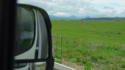 Driving through green hills on a cloudy day Stock Footage 339155663