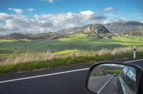 Driving through green wheat fields of Antequera County, Malaga, Spain Stock Photos