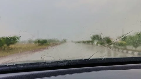 Driving Through Heavy Rain with Windshield Wiper Clearing Water on Moving Car Video stock 339800874
