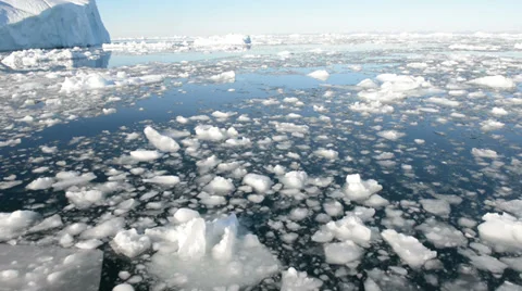 Driving through ice in arctic waters on a sunny day with lens flare Stock Footage 33910854