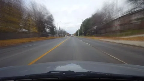 Driving Through Intersection on Suburban Street With Motion Blur Effect Stock Footage 98322160