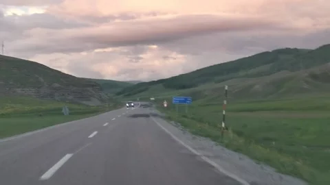 Driving through landscape with pink clouds Stock Footage 150279946