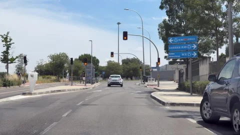 Driving through Madrid avenue approaching signalized intersection Видео 338195037