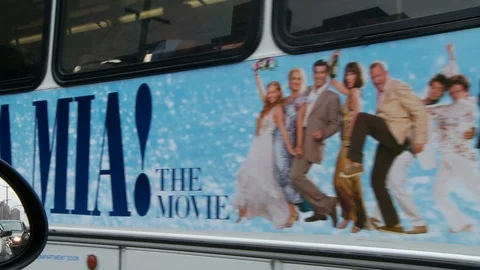 Driving through Manhattan with bus pulling away from curb, day. Video stock 107937496