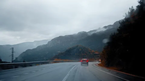 Driving through the misty Pyrenees mountains in Spain on a rainy day Stock Footage 303633797