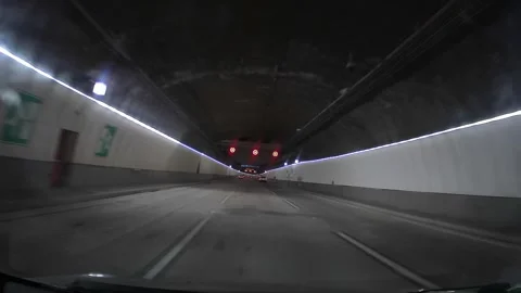 Driving through modern three-lane underground highway tunnel Video stock 326357728