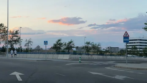 Driving through modern urban intersection at sunset in Madrid 库存影片 338195055