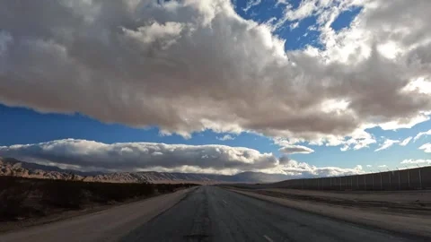 Driving through the mojave desert straight towards Stock Footage 244155255