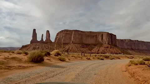 Driving Through Monument Valley Past The Three Sisters Rock Formation 動画素材 309049068