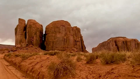 Driving Through Monument Valley Towards the Thumbs and Iconic Rock Formations 動画素材 309049952
