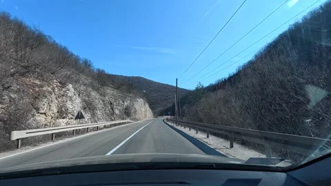 Driving through mountain passes under clear skies. Balkan, Eastern Europe, POV Video stock 331430359