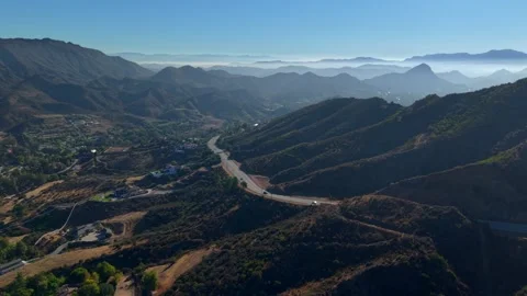 Driving Through Mountain Valley - Malibu Canyon Road during morning sunrise Stock Footage 324958363