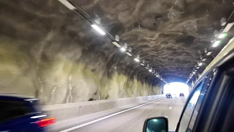 Driving through Rock-Cut Road Tunnel with Oncoming Cars in Sweden Stock Footage 347683113