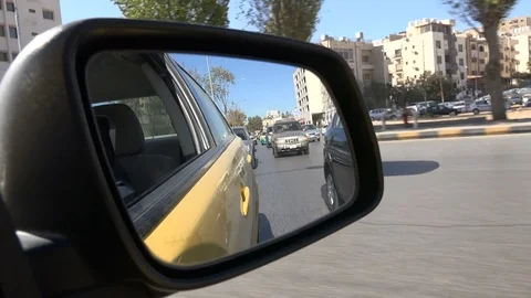 Driving through slow traffic in Amman, view from the mirror Видео 71480571